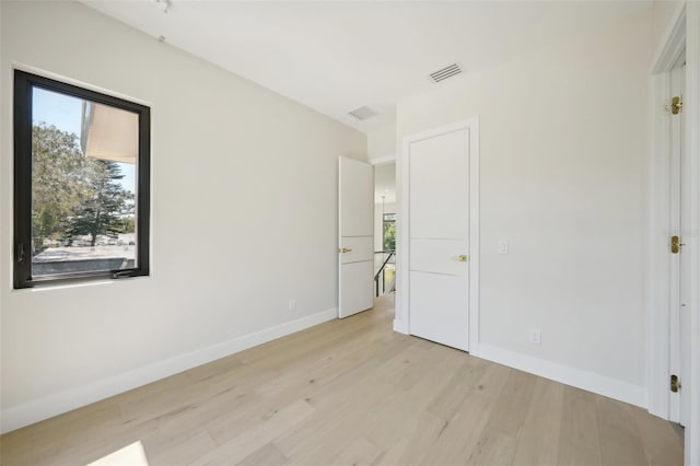 unfurnished bedroom with light wood-type flooring