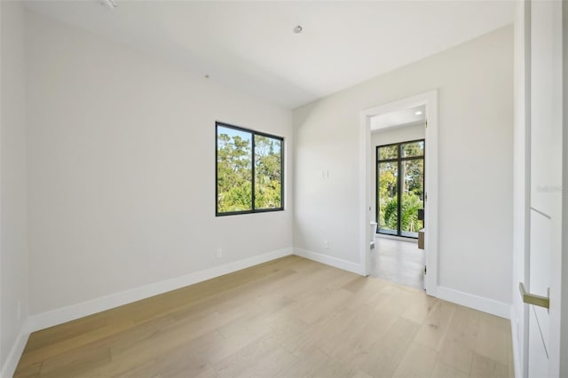 spare room with light hardwood / wood-style floors