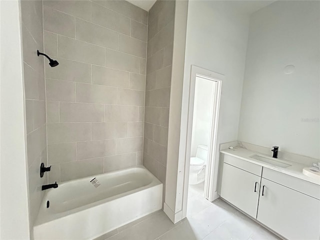 full bathroom featuring tile patterned flooring, vanity, toilet, and tiled shower / bath