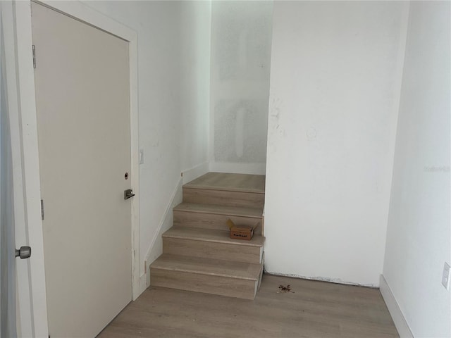 stairway featuring hardwood / wood-style flooring