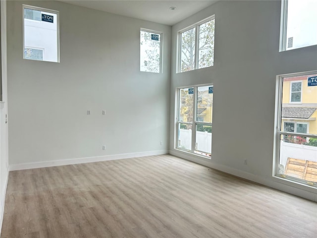 unfurnished room featuring a high ceiling