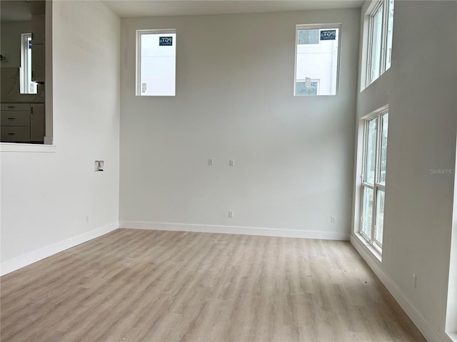 empty room with a healthy amount of sunlight and light wood-type flooring