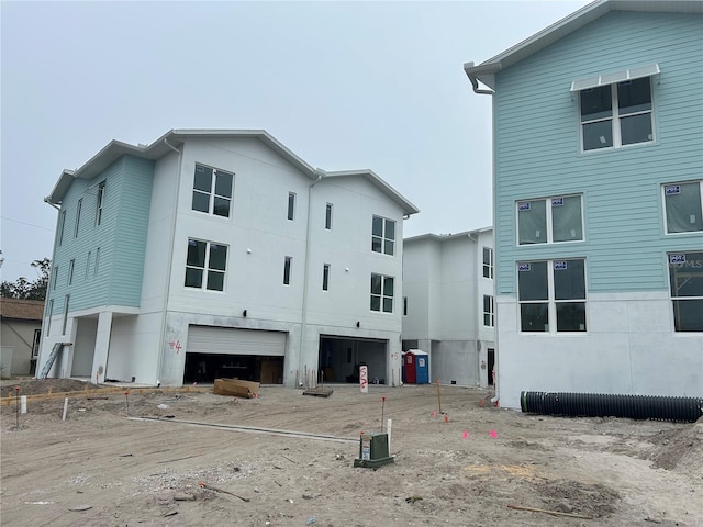 rear view of house featuring a garage