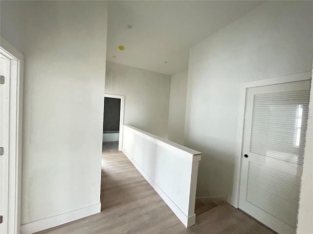 hallway with light hardwood / wood-style floors