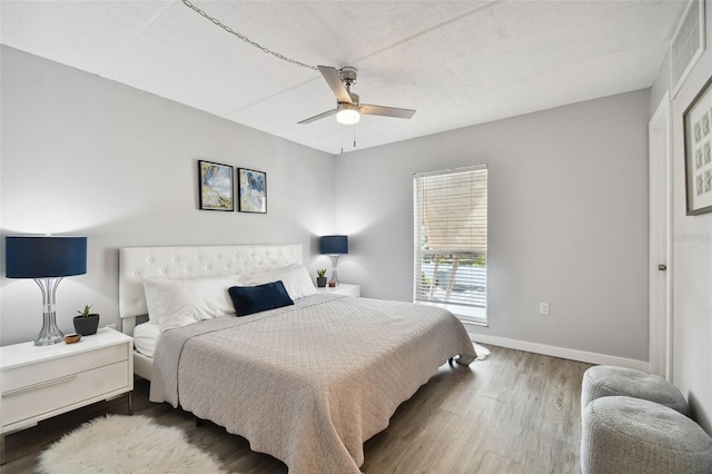 bedroom featuring ceiling fan and hardwood / wood-style flooring