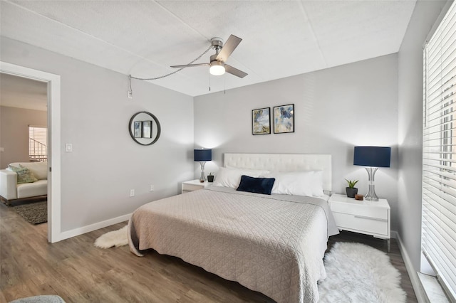 bedroom with ceiling fan and dark wood-type flooring