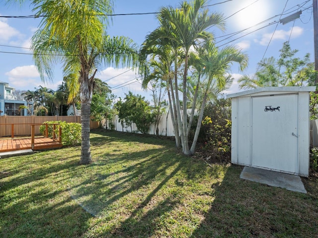 view of yard with a deck and a storage shed