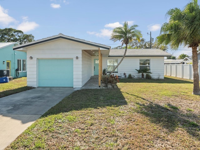 ranch-style home with a garage and a front lawn