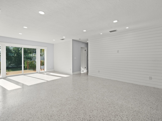 spare room with a textured ceiling