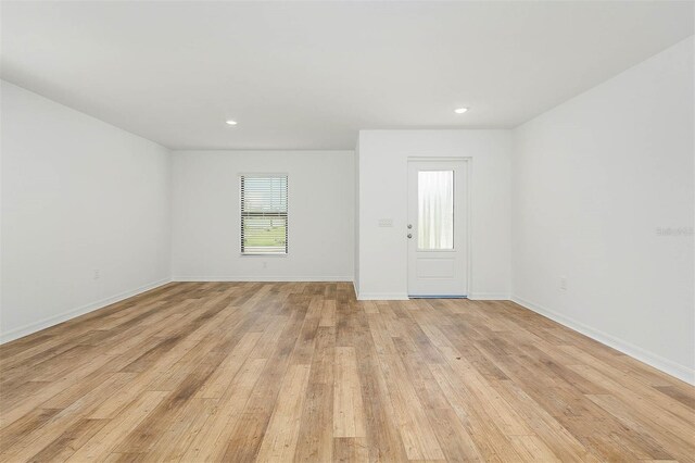 spare room featuring light hardwood / wood-style flooring