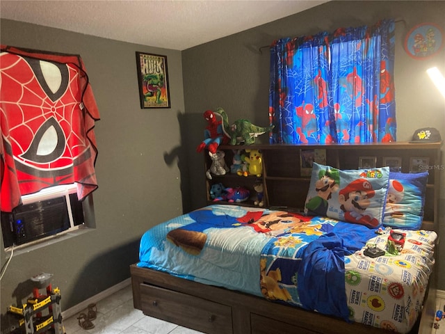 tiled bedroom featuring a textured ceiling