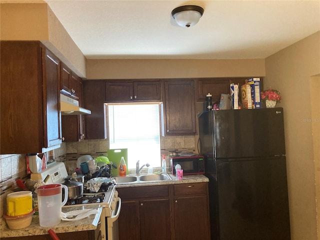 kitchen with black appliances, sink, dark brown cabinetry, and backsplash