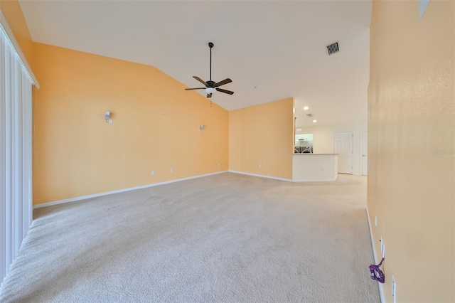 unfurnished living room with vaulted ceiling, light colored carpet, and ceiling fan