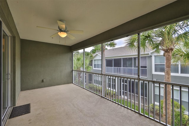 unfurnished sunroom featuring ceiling fan