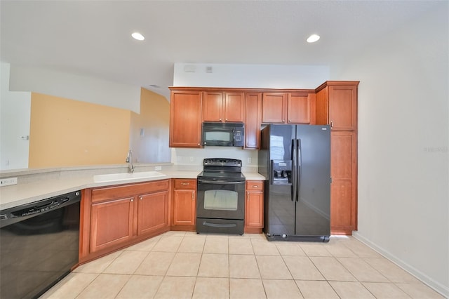 kitchen with light tile patterned flooring, sink, and black appliances