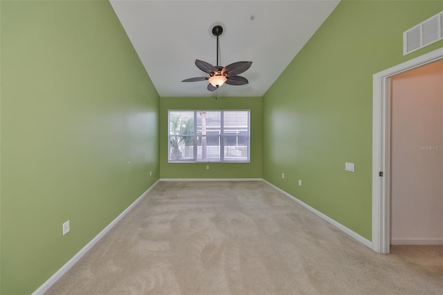 unfurnished room featuring vaulted ceiling, light colored carpet, and ceiling fan