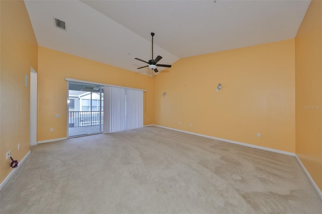 carpeted spare room featuring vaulted ceiling and ceiling fan