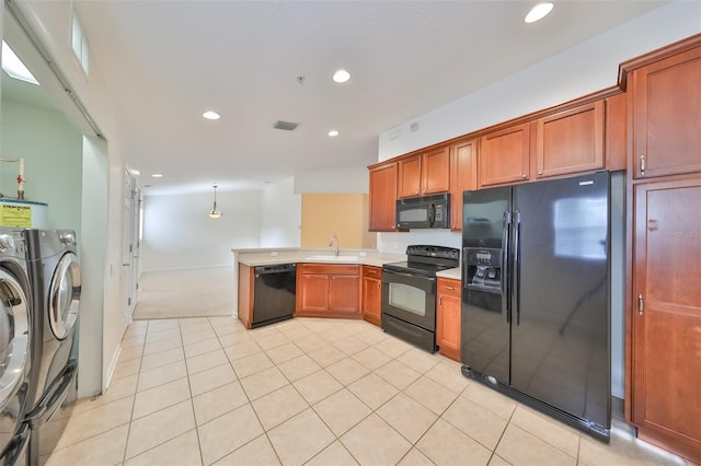 kitchen featuring sink, black appliances, separate washer and dryer, decorative light fixtures, and kitchen peninsula