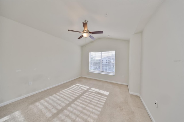 carpeted empty room with vaulted ceiling and ceiling fan