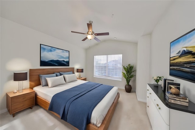 bedroom with vaulted ceiling, ceiling fan, and light colored carpet