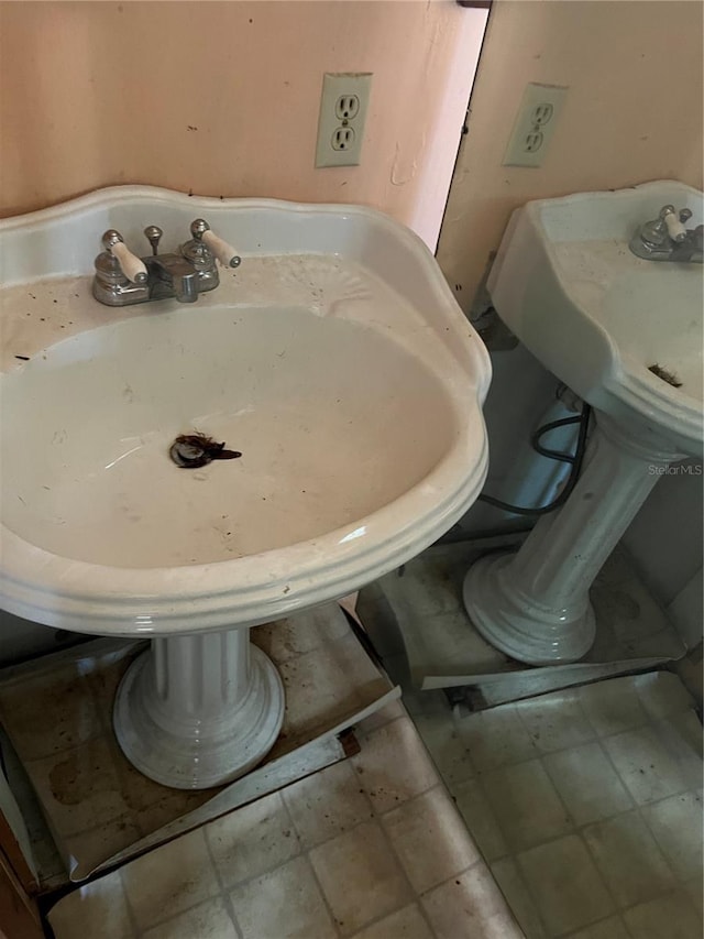 bathroom with tile flooring and sink