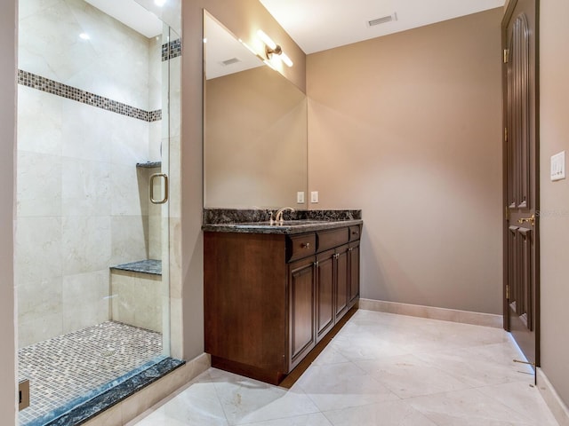 bathroom featuring a stall shower, visible vents, vanity, and baseboards