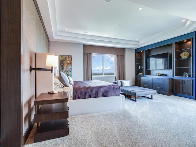 bedroom featuring carpet floors, a raised ceiling, and recessed lighting