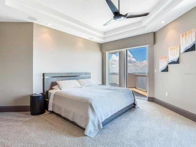 bedroom featuring ceiling fan, baseboards, access to outside, carpet, and a raised ceiling