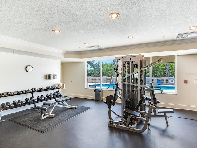 workout area featuring a textured ceiling, recessed lighting, visible vents, baseboards, and crown molding