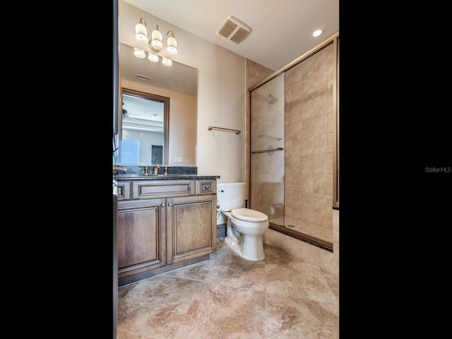 bathroom with toilet, vanity, a shower stall, and visible vents