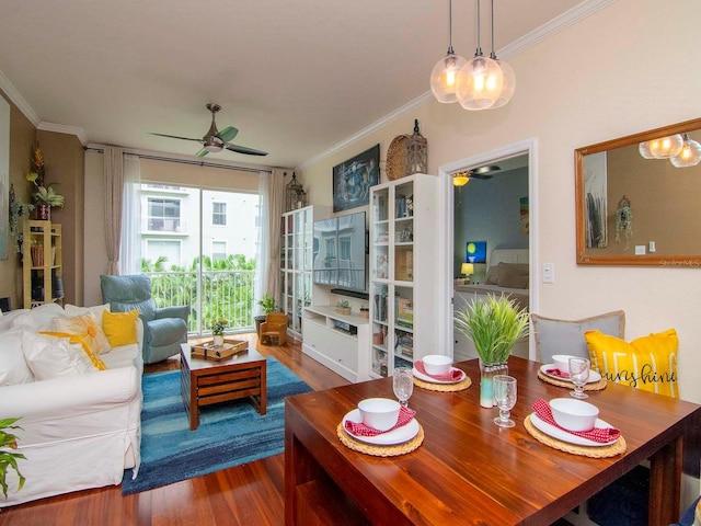 dining space with wood-type flooring, ceiling fan, and ornamental molding