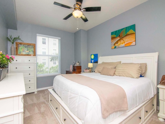 bedroom featuring light carpet and ceiling fan