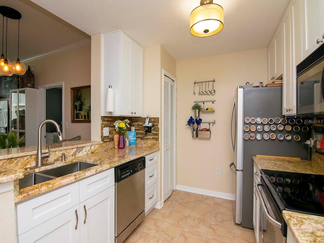 kitchen featuring white cabinets, appliances with stainless steel finishes, backsplash, and light stone countertops