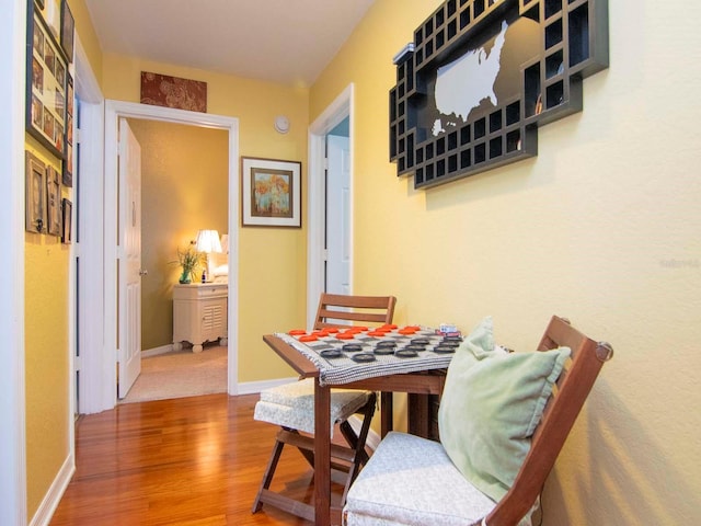 dining space with wood-type flooring