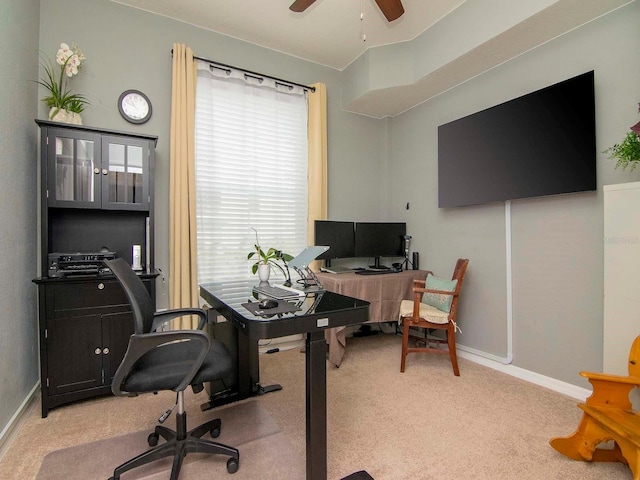 carpeted office space with ceiling fan