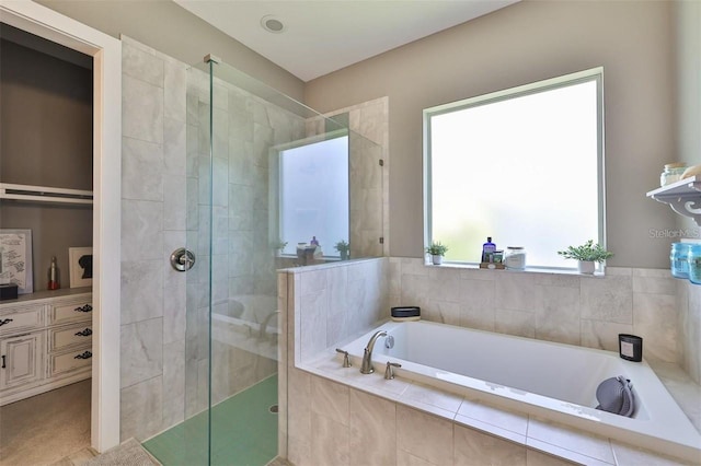 bathroom featuring vanity and plus walk in shower