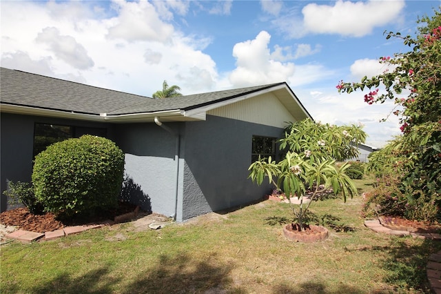 view of property exterior with a yard