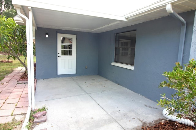 doorway to property featuring a patio area