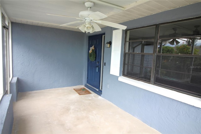 view of exterior entry with ceiling fan