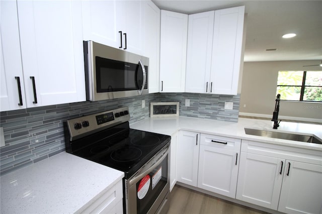 kitchen with tasteful backsplash, stainless steel appliances, sink, and dark hardwood / wood-style flooring