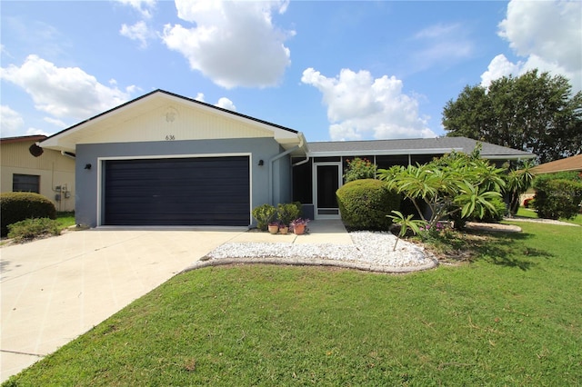 ranch-style home featuring a front lawn and a garage