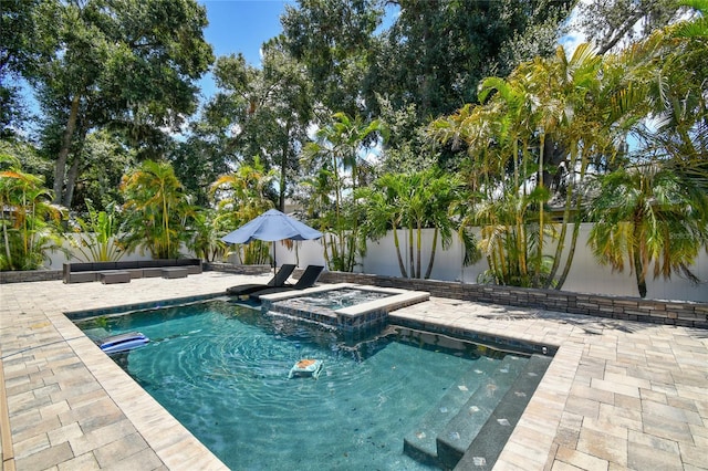 view of pool featuring an outdoor hot tub and a patio