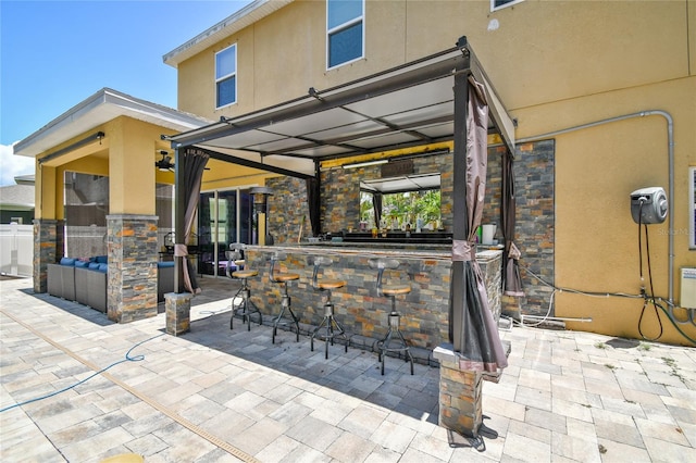 view of patio featuring exterior bar