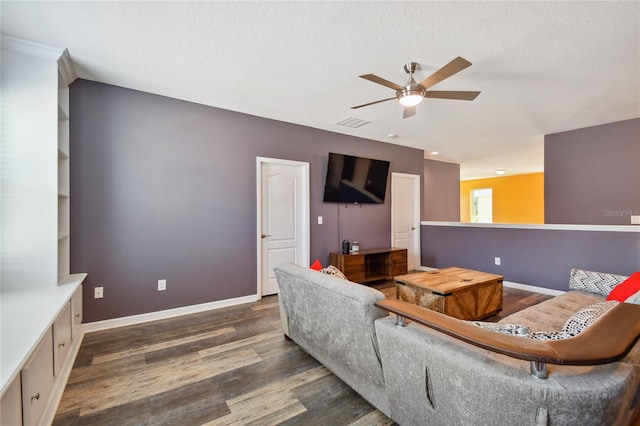 living room featuring ceiling fan and dark hardwood / wood-style flooring