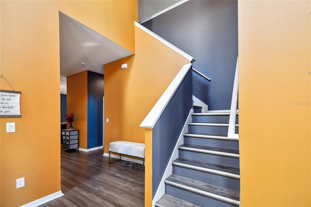 stairway with dark hardwood / wood-style flooring