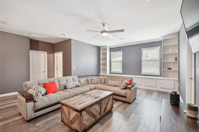 living room featuring a textured ceiling, ceiling fan, and hardwood / wood-style flooring