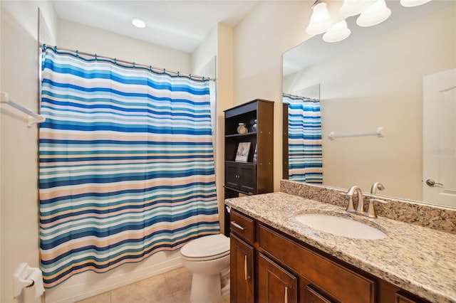 bathroom with tile flooring, oversized vanity, and toilet