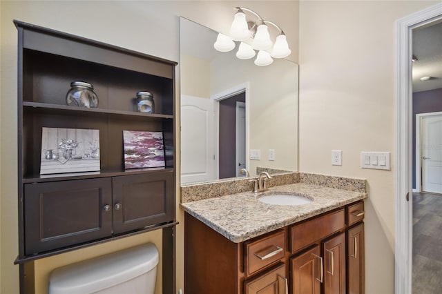 bathroom with vanity, hardwood / wood-style floors, and toilet