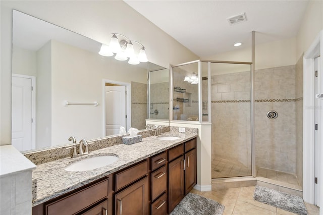 bathroom with large vanity, walk in shower, dual sinks, tile flooring, and an inviting chandelier