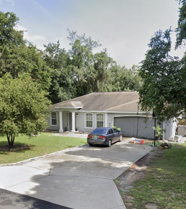 ranch-style home featuring a front yard and a garage